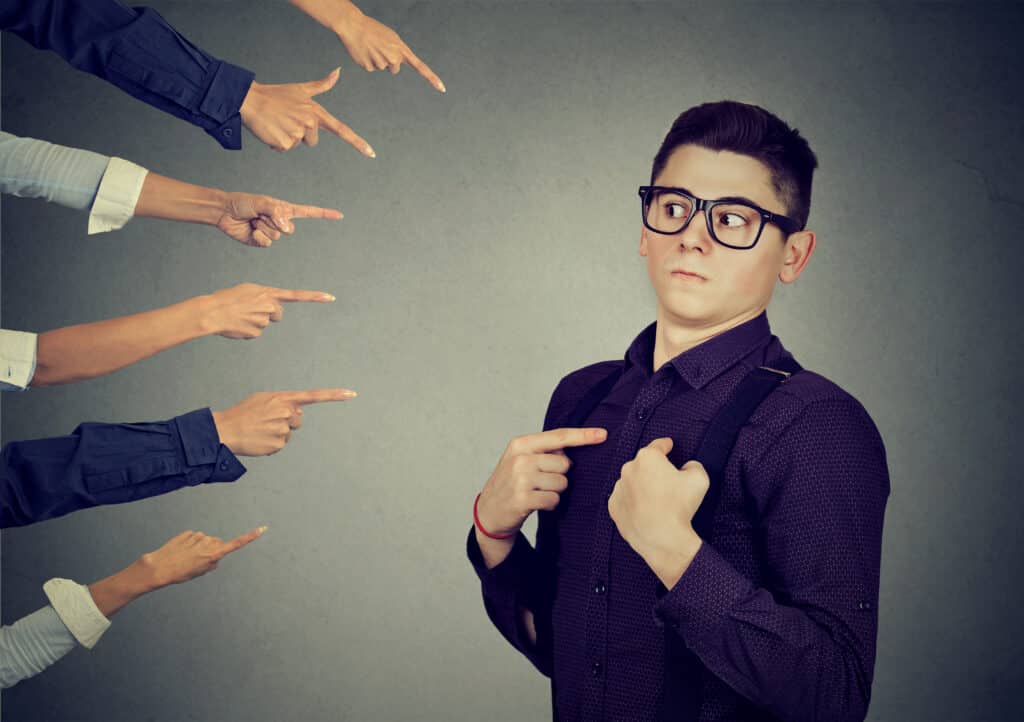 Blaming you. Anxious man judged by different people pointing fingers hands at him. Concept of accusation of guilty guy. Negative human emotions face expression feeling